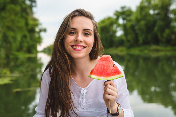 woman with watermelon outdoor by the river - Foto, Imagen