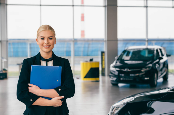 sales agent standing in car showroom - Photo, Image