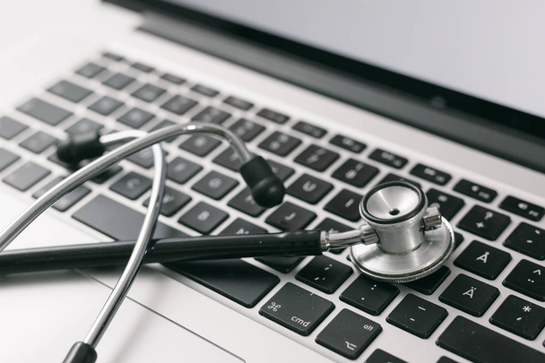 closeup view of stethoscope with laptop keyboard - Photo, Image