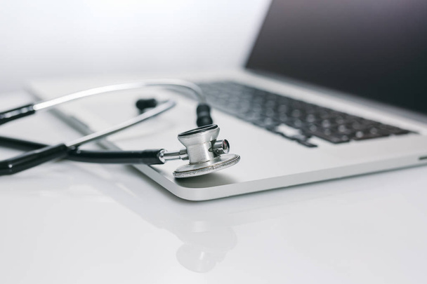 closeup view of stethoscope with laptop keyboard - Foto, imagen
