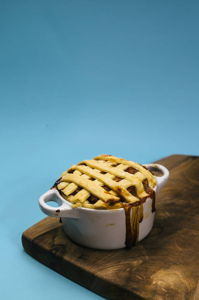 sweet apple pie on wooden board on blue background - Photo, image