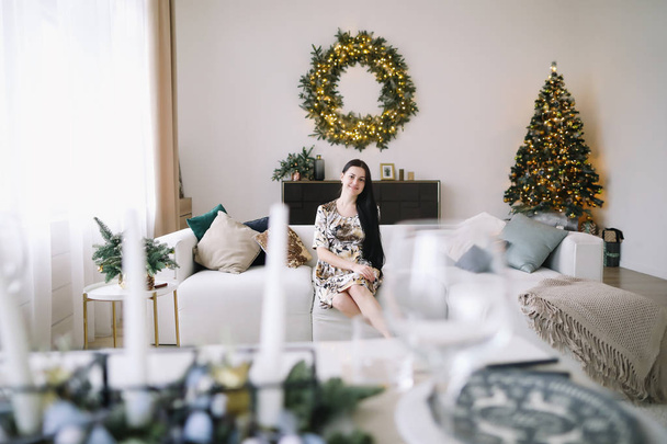 Girl in a festive interior with new year decorations. Christmas and  New Year concept - Fotó, kép