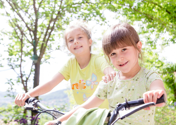 Two little girls with bikes - Foto, imagen
