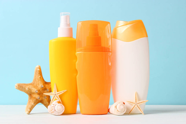 Set of different sun creams on a colored background. Cosmetics for sun protection. - Photo, image