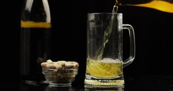 Pouring Cold Light Beer from bottle into a glass. Craft Beer close-up - Кадры, видео