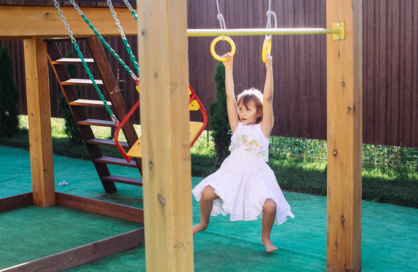 Happy little girl at playground - 写真・画像
