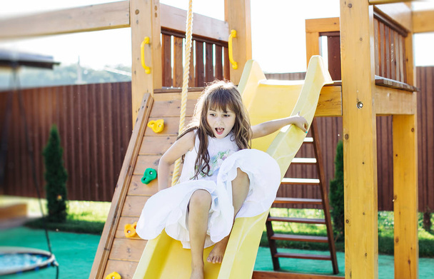 Happy little girl at playground - Fotografie, Obrázek
