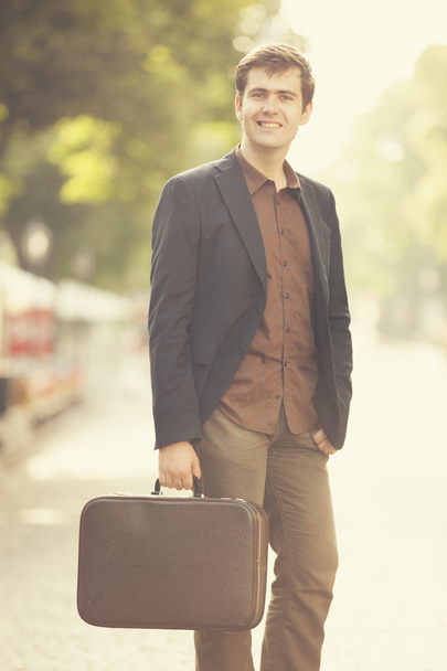 Man with suitcase walking outdoors - Foto, Bild
