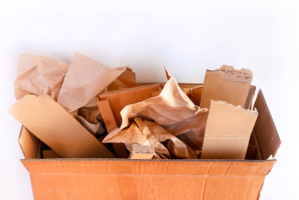 Cardboard box with crumpled paper and cardboard pieces - Photo, Image