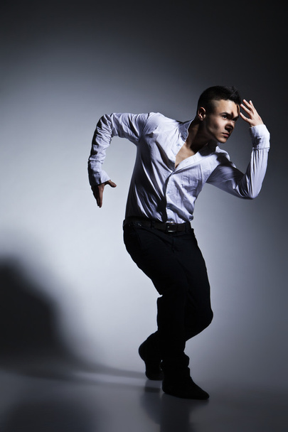 Modern style dancer posing on grey background - Foto, immagini