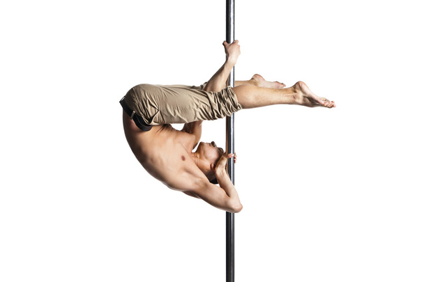 Young strong pole dance man isolated - Foto, afbeelding