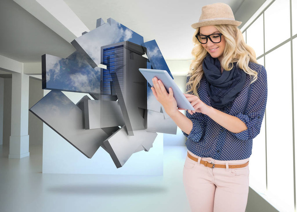 Smiling trendy blonde using tablet computer against white room with screen - Foto, Bild