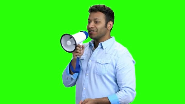 Cheerful young man with megaphone on green screen. - Footage, Video