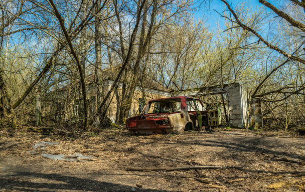 Old abandoned broken car. Exclusion zone of the Chernobyl nuclear disaster - Photo, Image