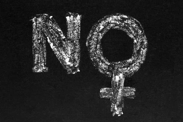 NO matriarchy. Handwritten white chalk female sign / symbol on blackboard. Gender wars concept - Photo, Image