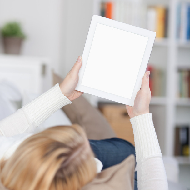 Woman Reading On Ebook While Lying On Sofa - 写真・画像