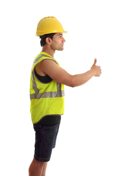 A construction worker, builder or other handyman or tradesman giving a thumbs up gesture.  White background. - Foto, imagen