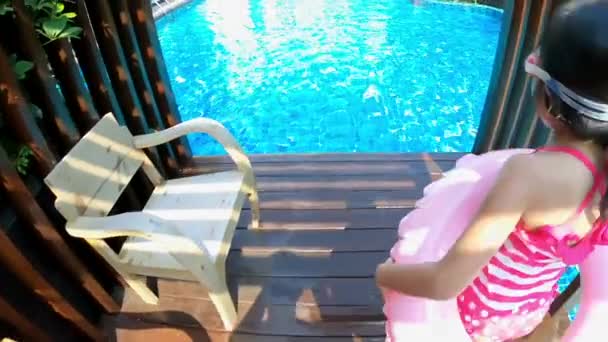 girl jump into swimming pool - Materiaali, video