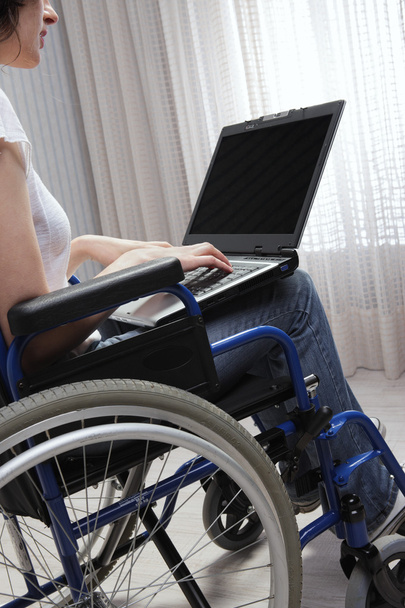 Disabled young woman using laptop - Photo, Image