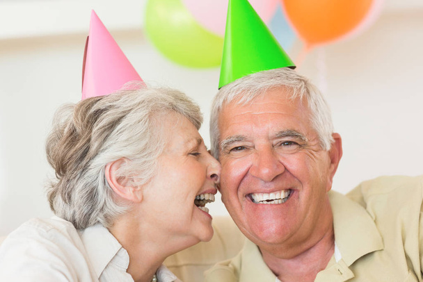 Senior couple celebrating a birthday together at home in the living room - Foto, afbeelding