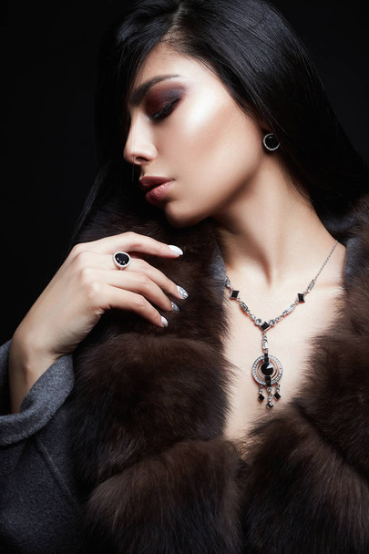Beautiful brunette Girl in Jewelry and Fur - Photo, Image