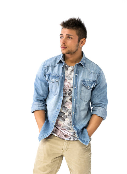 Handsome young man standing with open denim shirt, looking at camera, isolated - Φωτογραφία, εικόνα