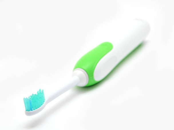 Electric toothbrush on a white background, closeup shot. - Foto, imagen