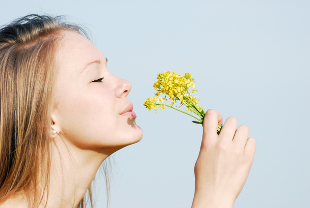 The girl smells flowers - Photo, Image