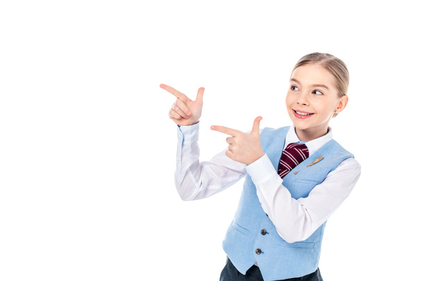 happy schoolgirl in formal wear pointing with fingers Isolated On White with copy space - Photo, Image