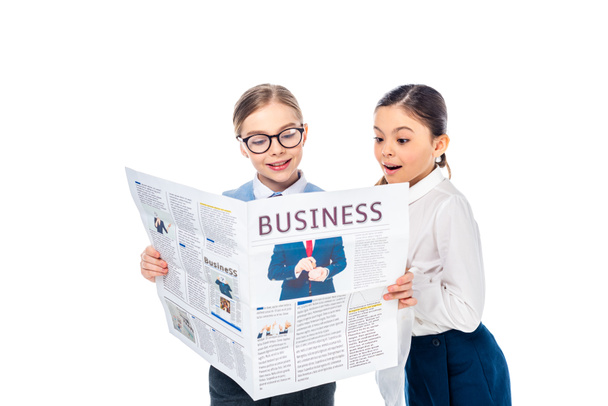 adorable schoolgirls in formal wear reading business newspaper Isolated On White - Valokuva, kuva