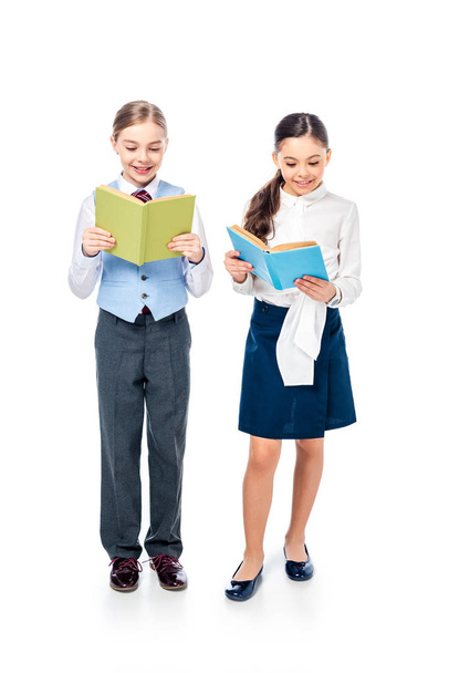 smiling schoolgirls in formal wear reading books On White - Foto, immagini