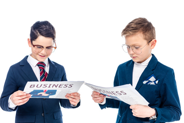 μαθητές με γυαλιά που προσποιούνται ότι είναι επιχειρηματίες διαβάζοντας εφημερίδες απομονωμένος στο λευκό  - Φωτογραφία, εικόνα