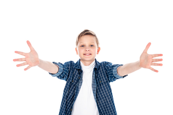 adorable smiling boy in casual clothes with outstretched hands isolated on white - Фото, изображение