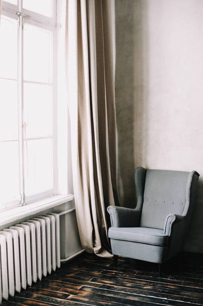 Gray armchair. Modern armchair by the window. Series of furniture. Modern interior.  - Foto, imagen
