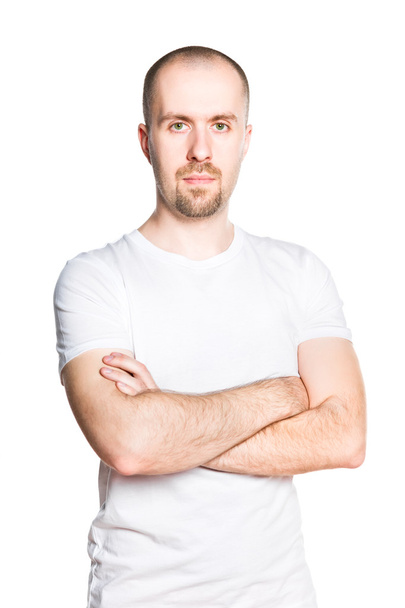 Handsome young man with folded arms in white t-shirt isolated on white - Foto, immagini