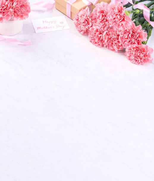 Design concept - Beautiful bunch of carnations on marble white background, top view, copy space, close up, mock up. Mothers day gift idea inspiration. - Photo, image