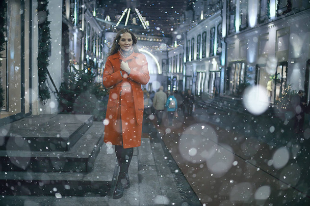 winter night in the city lights / adult girl in a coat walk in the city, fashionable stylish image of a beautiful model - Photo, Image