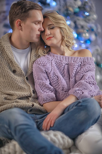 New Year's photo people / young man and girl in the Christmas interior, cozy decorated house - Фото, изображение