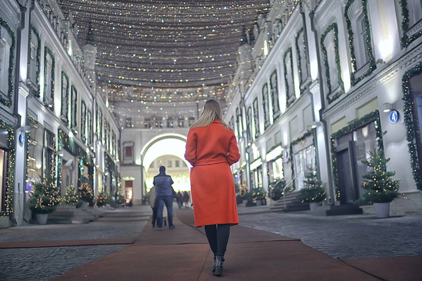 winter night in the city lights / adult girl in a coat walk in the city, fashionable stylish image of a beautiful model - Valokuva, kuva