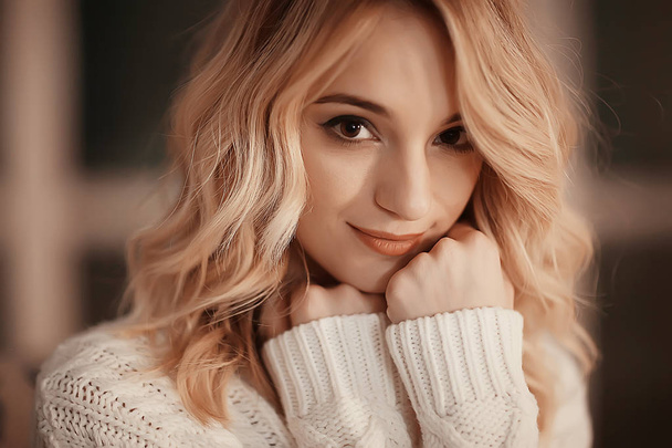 portrait of a cute girl sweater studio / beautiful young model, young blonde - Foto, Imagen