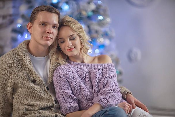 New Year's photo people / young man and girl in the Christmas interior, cozy decorated house - Fotografie, Obrázek
