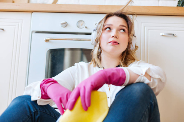 Low angle of a pleasant young woman in the kitchen - Photo, image