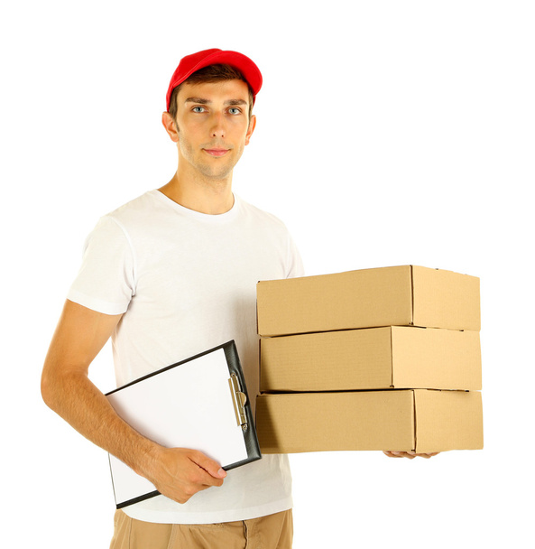 Young delivery man holding parcels and clipboard, isolated on white - Фото, зображення