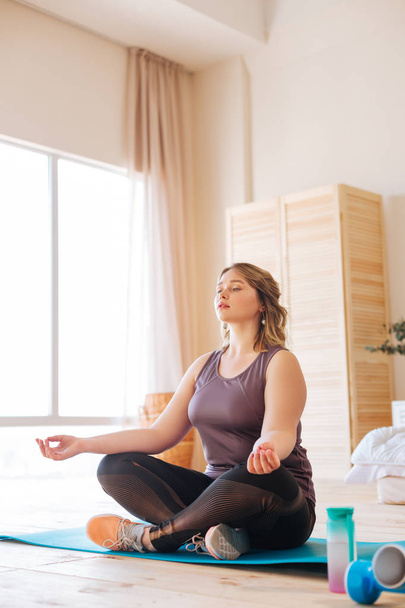 Beautiful peaceful fit woman trying to meditate - 写真・画像