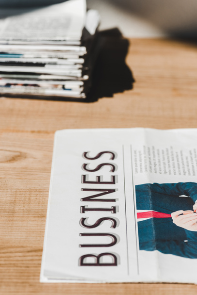 selective focus of business print newspaper on wooden table  - Foto, imagen