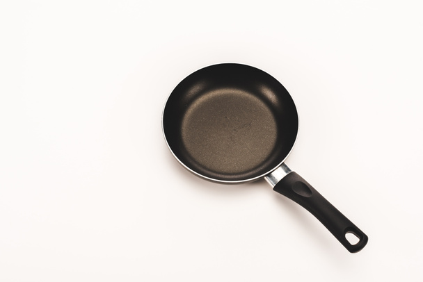black frying pan with handle on white background with copy space - Photo, Image