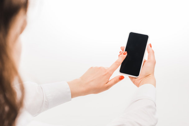 selective focus of woman using smartphone with blank screen on white background - Zdjęcie, obraz