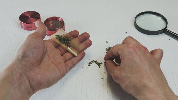 Приготування і прокатка марихуани конопель суглоба
 - Фото, зображення