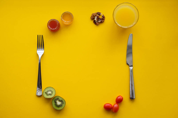 Knife with fork on a yellow background with copy space - Zdjęcie, obraz