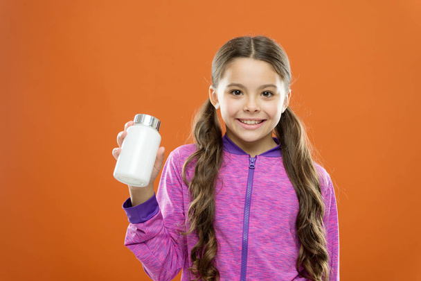 Health care. Girl long hair hold medicines bottle. Vitamin concept. Need vitamin supplements. Child cute girl take some medicines. Treatment and medicine. Natural product. Take vitamin supplements - Fotoğraf, Görsel